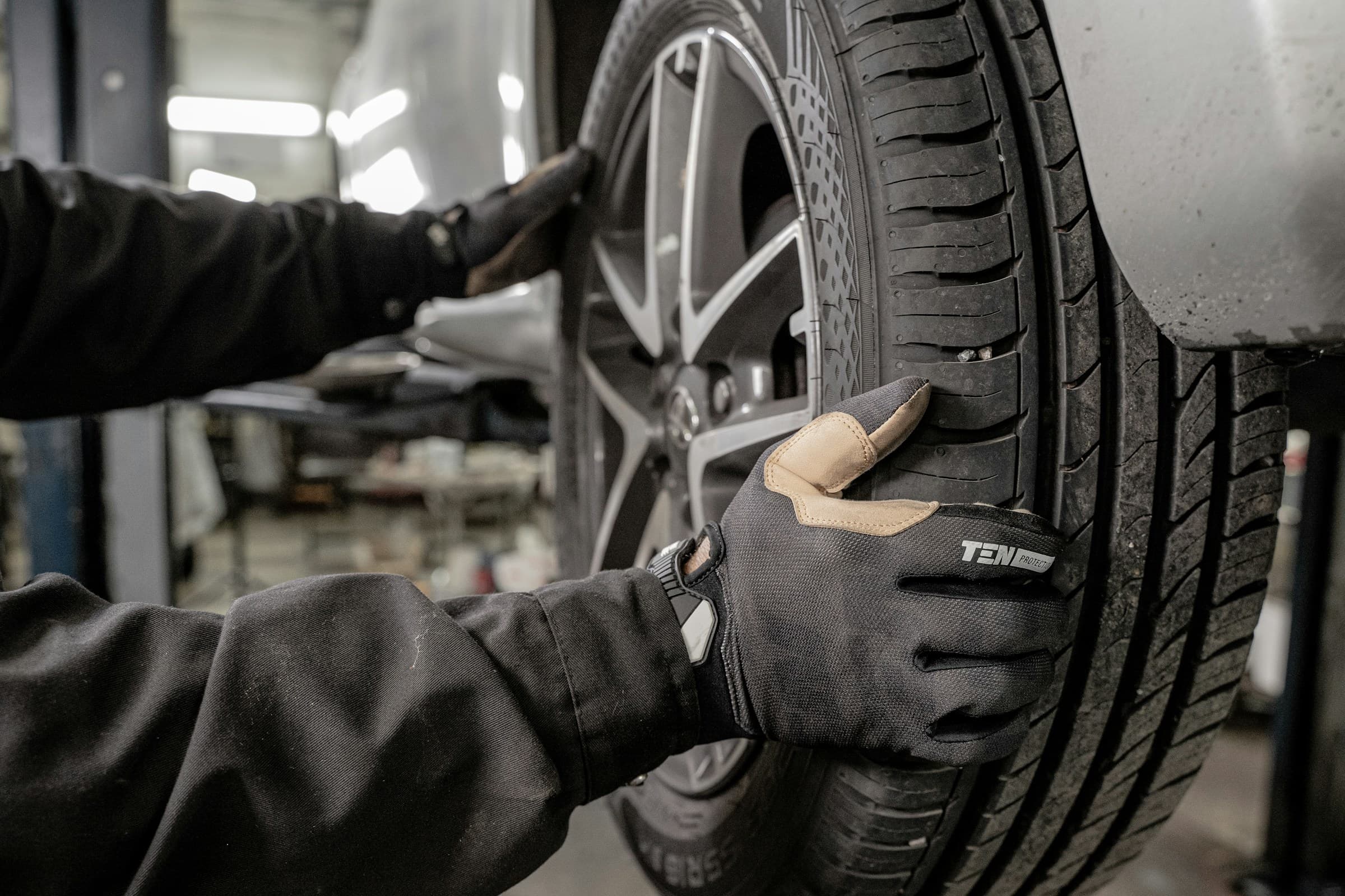 Mechanic checking car wheel during professional vehicle service